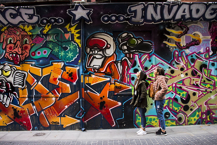 two, woman, standing, front, creative, graffiti, wall