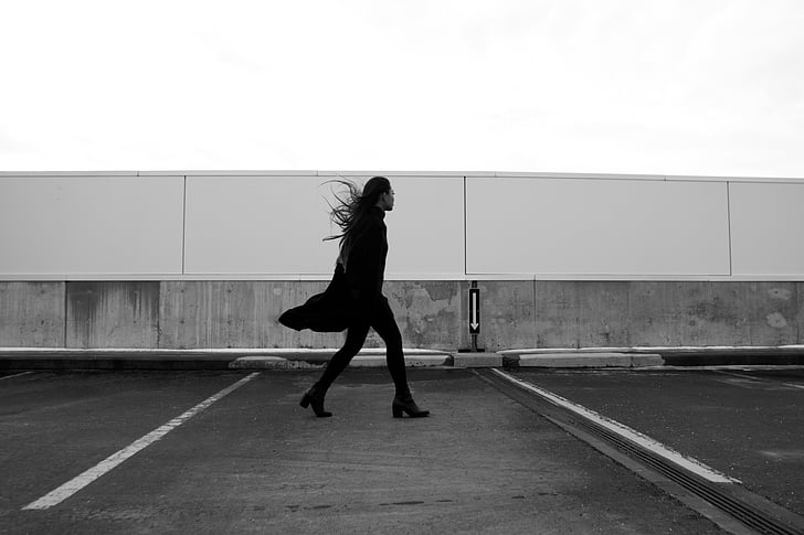 woman, black, coat, walking, parking, lot, daytime