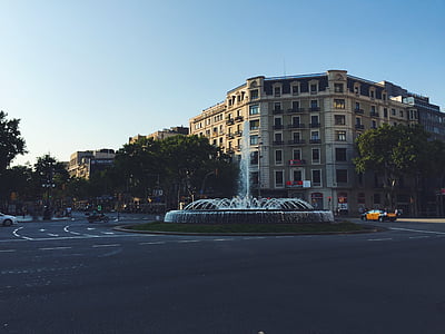 buildings, cars, city, fountain, road, roundabout, street