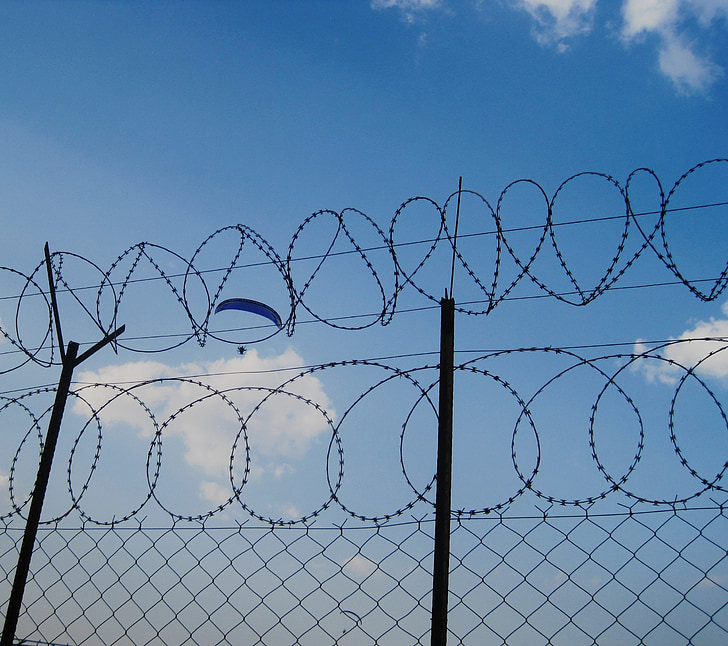 sky, blue, parachute, falling, gliding, drifting fence, barbed wire