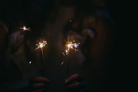 person, holding, firecrackers, sparkling, light, dark, night