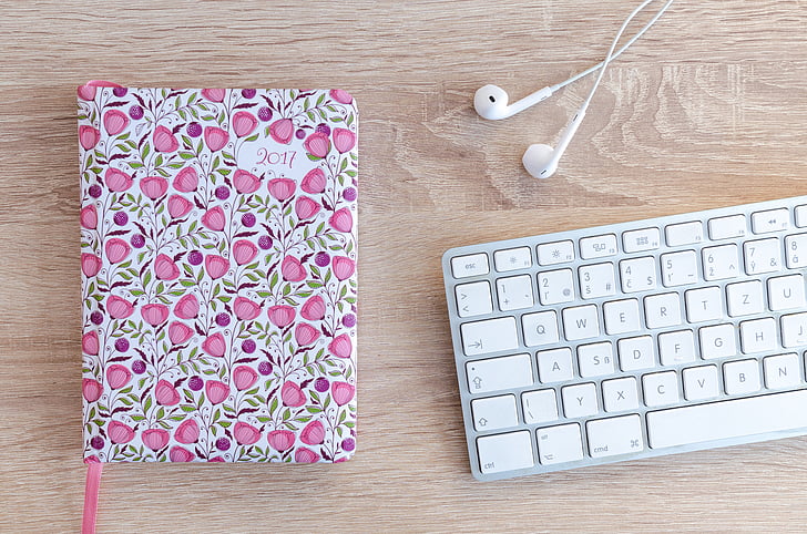 lifestyle, office, desk, notebook, planner, flowers, earphones