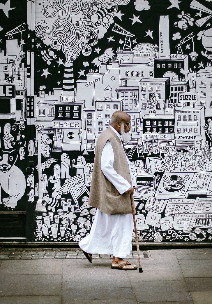 man, white, robe, holding, cane, street, daytime