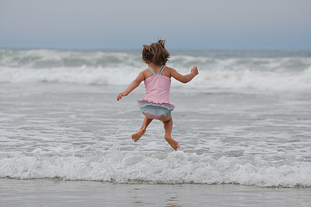 girl, beach, ocean, waves, jumping, bathing suit, pacific ocean
