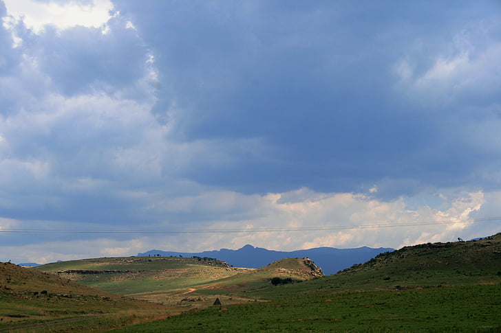 rolling hills, folds, green ridge, far blue mountains, overcast, sky, clouds