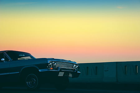 black, car, beside, white, concrete, barrier, sunset