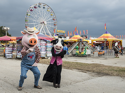 costumed pig and cow, characters, carnival, fair, cartoon, ferris wheel, fun
