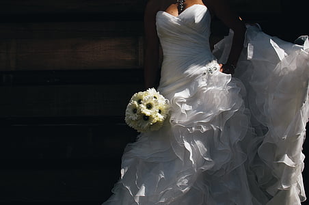 woman, wearing, wedding, gown, holding, bouquet, flowers