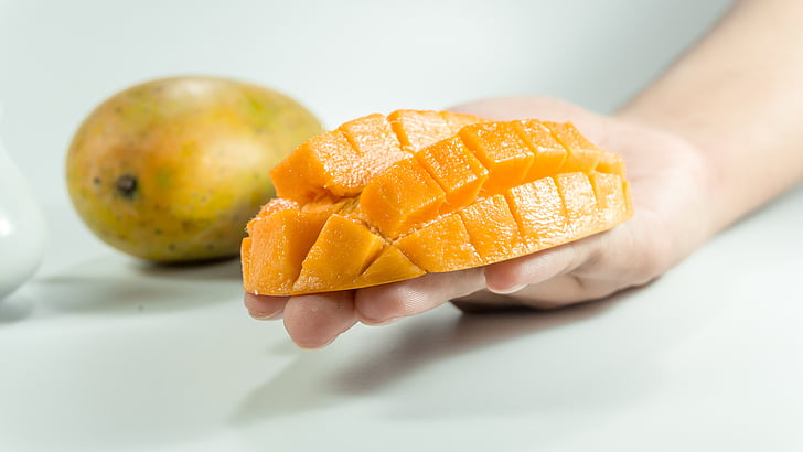 mango, slice, on hand, yellow, isolated, cube, fruit