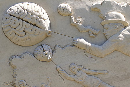 brain, balloon, man, hat, child, woman, sand sculpture