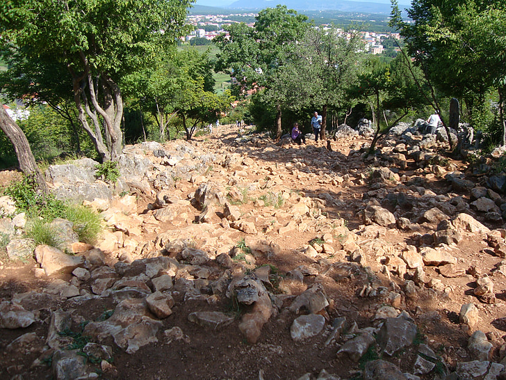 our lady of medjugorje, pilgrim, pilgrimage, stations of the cross, rocks, cliff, road