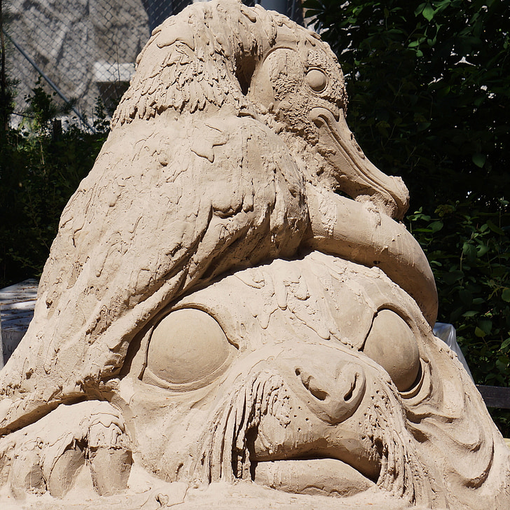 sand sculpture, work of art, made of sand, bird and big eyes