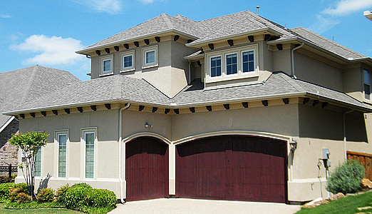 spanish style home, house, residence, maroon garage doors, blue sky, clouds