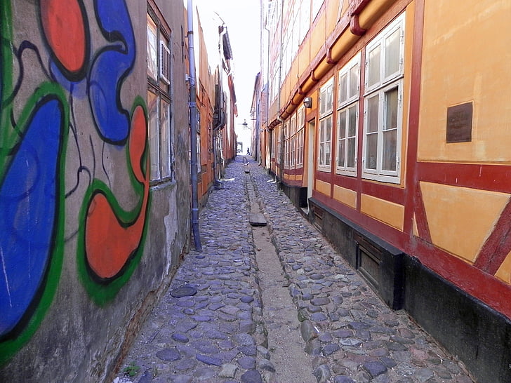 cobblestone street, narrow street, graffiti, window, railroad Track, train, transportation