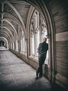 architecture, archway, ceiling, hallway, man, person, standing