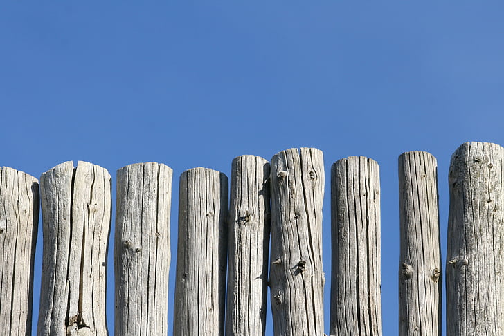 poles, wood, fence, worn, faded, sun-bleached, blue sky