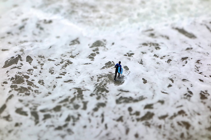 man, black, holding, blue, board, daytime, beach