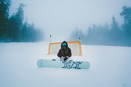 person, black, hoodie, holding, white, snowboard, snow