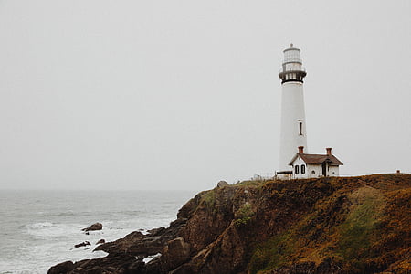 white, lighthouse, hill, nearby, body, water, day