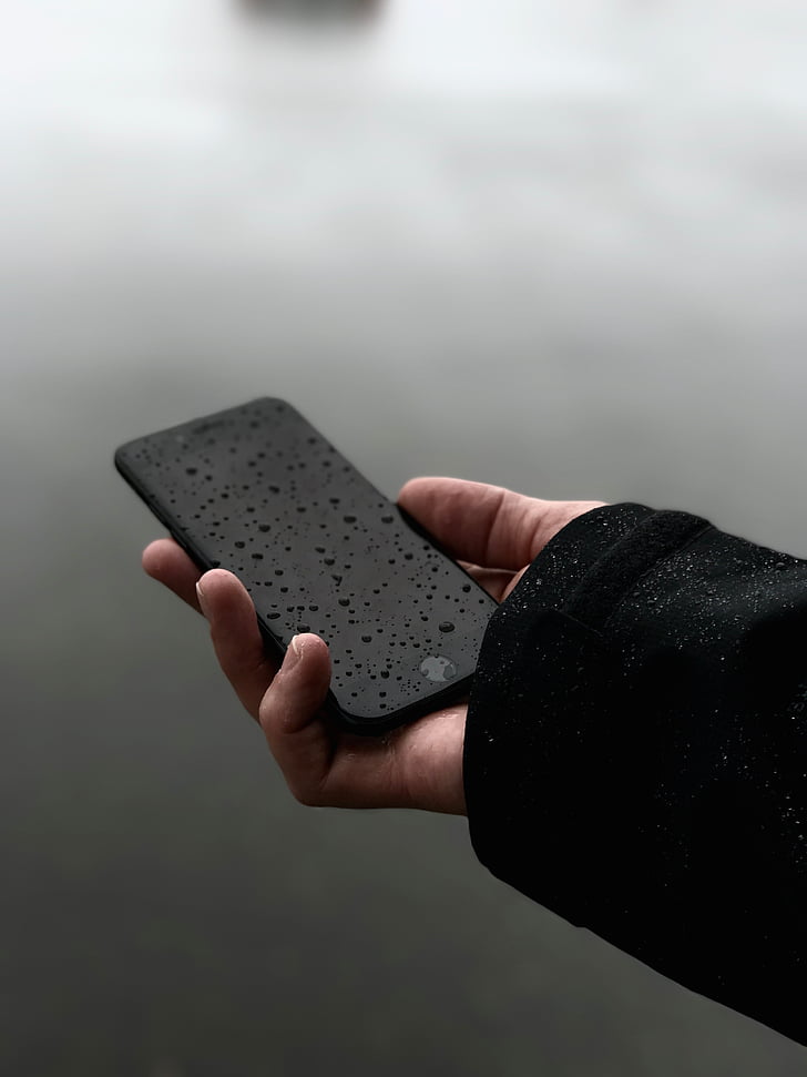 person, holding, matte, black, iphone, rainy, season