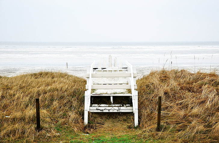 white, wooden, chair, near, ocean, water, daytime