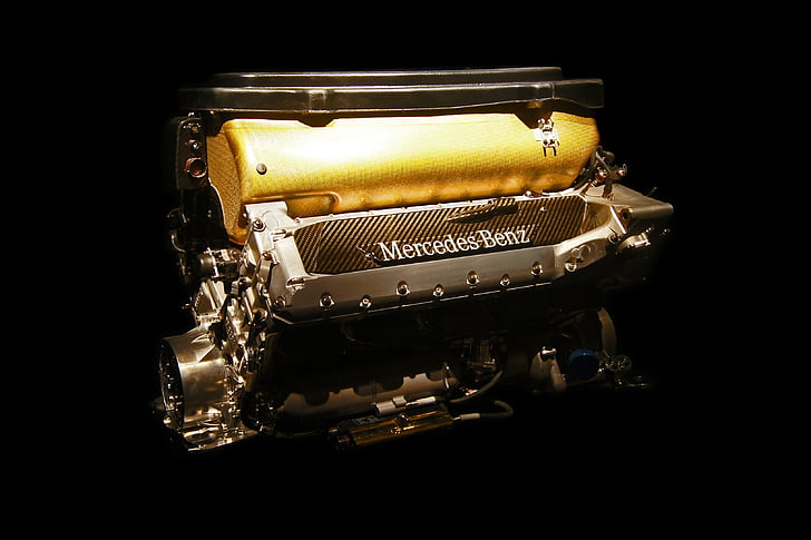 motor Mercedes, motor del cotxe, cavalls de potència, groc, fons negre, estudi de tir, close-up