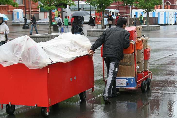 vendor, cart, red, covered, pulling and pushing, cart with goods, wet surface