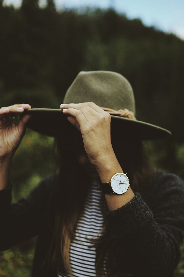 woman, holding, hat, wearing, analog, watch, leather
