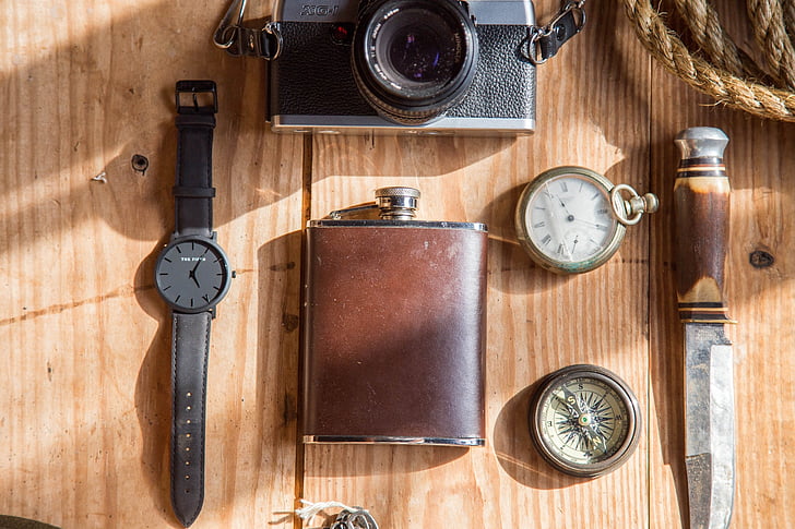 brown, hip, flask, near, analog, watch, compass