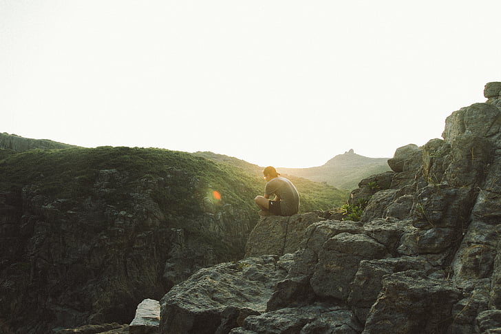 man, sitting, beside, edge, rock, sunrise, sunset