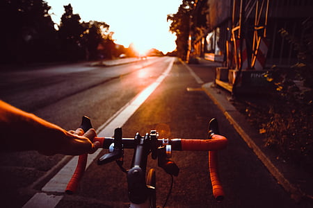 person, riding, black, orange, road, bicycle, facing