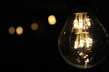 black background, bulb, close-up, creativity, dark room, electric light, electricity