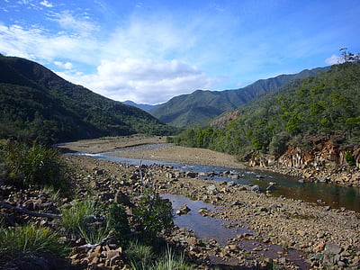 Ny Kaledonien, landskab flodlejet, himlen skyer, vand, sten, bjerge, naturskønne