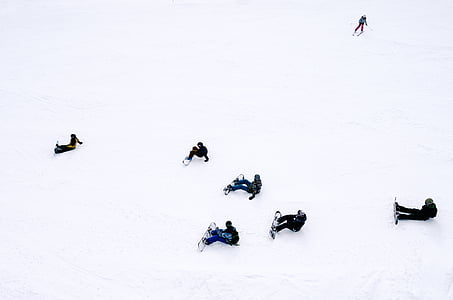 people, sitting, snow, wearing, snowboards, daytime, winter