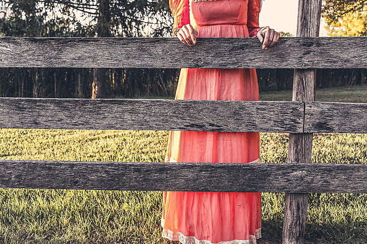woman, red, dress, holding, brown, wooden, fence