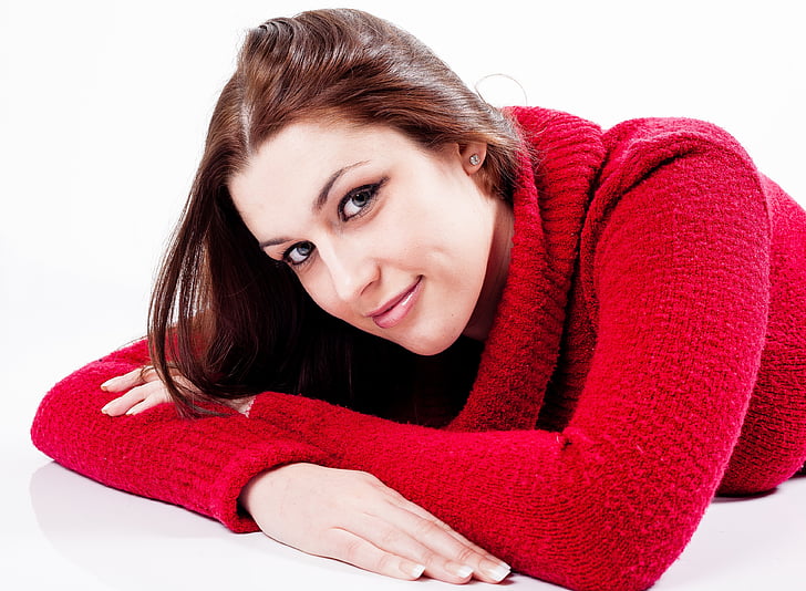 young, woman, female, smiling, lying down, jumper, red