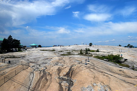 atop stone mountain, high up, unrecognizable people, people, height, surface, rock