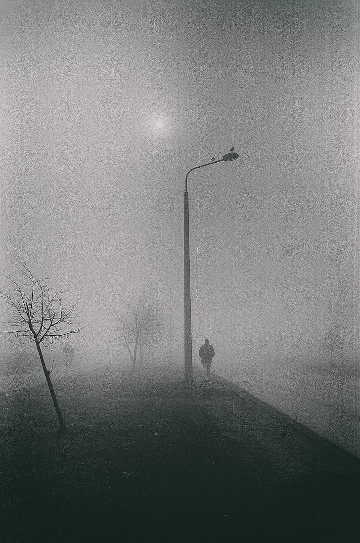 greyscale, photo, man, standing, near, street, lamp