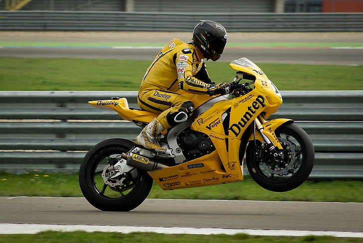 person, wearing, yellow, racing, suit, black, helmet