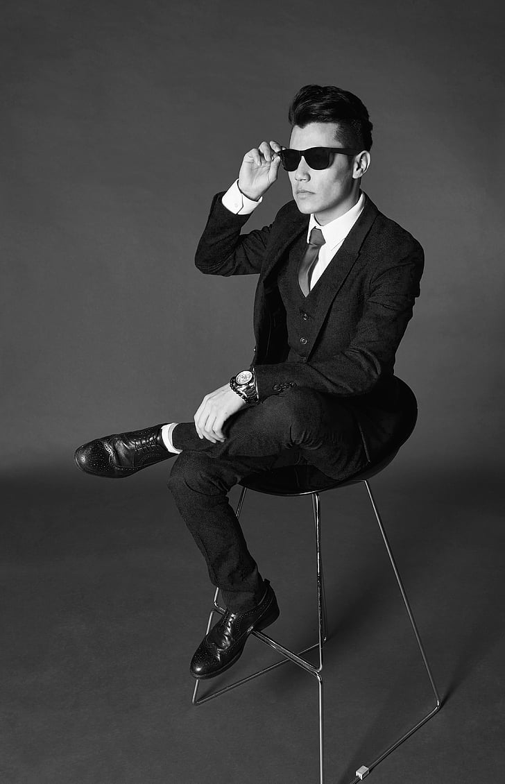 actor, adult, black-and-white, chair, dark, designer suit, fashion