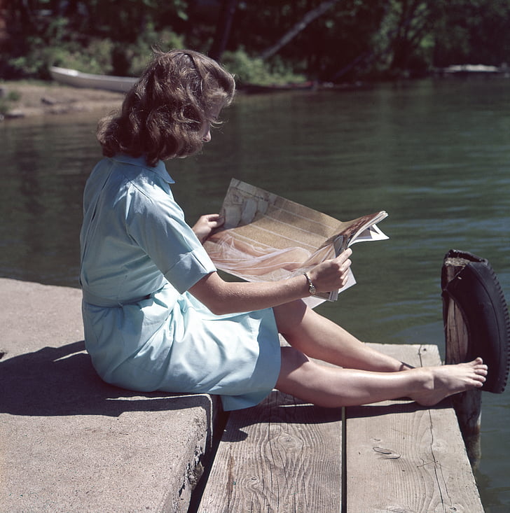 woman, sitting, rive, dock, reading, magazine, people