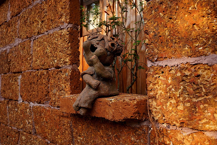 wall, sculpture, brickwork, terracotta figurine, incident light, architectural form, funny