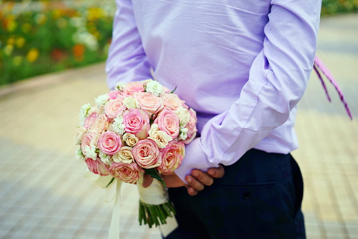 holding flowers, the groom, location, wedding, marriage, gifts, bouquet