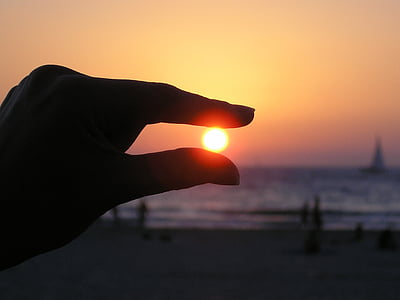 sun in the hand, fingers, sunset, silhouette, sky, seashore, ocean