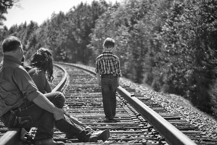 boy, parents, walking, railroad tracks, black and white, portrait, trees