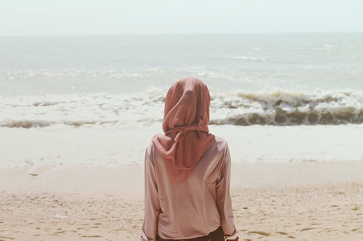 person, wearing, brown, hijab, sitting, sea, shore