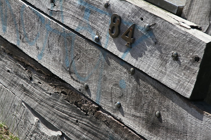 number 84, wood, pine sleepers, fence, wooden fence, weathered fence, house number