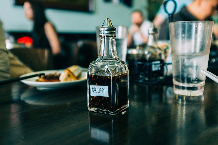 close, photo, black, labeled, bottle, wooden, table