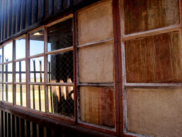 window, row of windows, opaque panes, clear reflecting panes, light, corrugated iron, shed