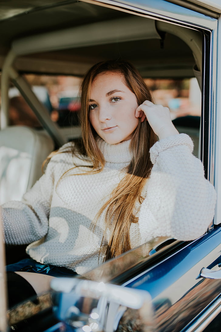 woman, wearing, white, knit, sweater, sitting, car